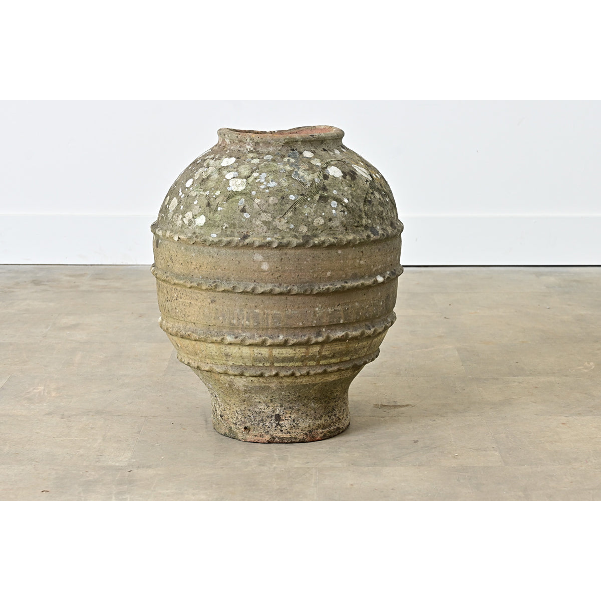 Vintage ceramic vase on a wooden surface with a white background